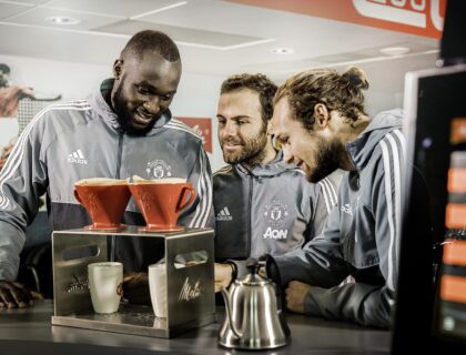 soccer players drinking coffee