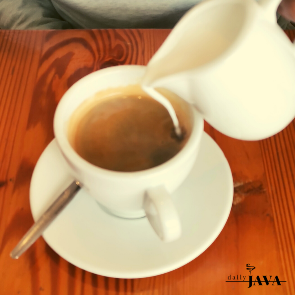 Americano in white cup on wooden table