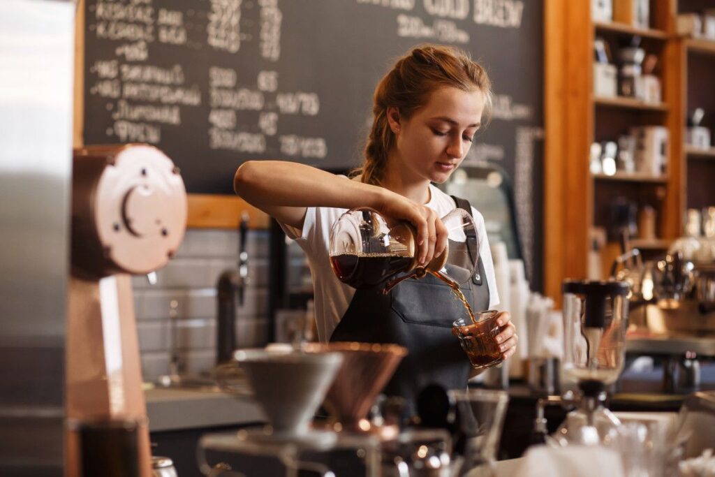 Female coffee barista making coffee