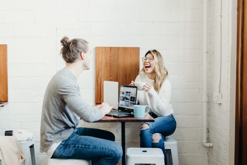 girl and guy enjoying coffee in coffee shop