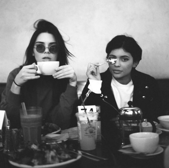 Black and White image of Kylie and Kendall Jenner drinking coffee