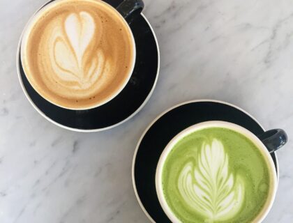 a cup of coffee and a cup of matcha on a table